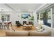 Open living space with hardwood floors, modern furniture, and a charming brick fireplace at 3437 W 35Th Ave, Denver, CO 80211