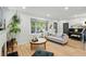 Bright living room features hardwood floors, piano, and large window for natural light at 3437 W 35Th Ave, Denver, CO 80211