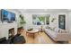 Bright living room features hardwood floors, a stylish fireplace, and large window at 3437 W 35Th Ave, Denver, CO 80211
