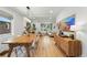 Open-concept living space with dining area, hardwood floors, and modern decor; lots of natural light at 3437 W 35Th Ave, Denver, CO 80211