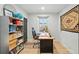 Functional home office space with a built-in bookshelf, desk, and neutral decor at 3437 W 35Th Ave, Denver, CO 80211