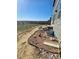 Side yard featuring garden beds and a partially installed irrigation system at 1800 Vantage Pkwy, Berthoud, CO 80513