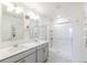 Bright, modern bathroom with dual vanity, glass shower, and contemporary finishes at 1800 Vantage Pkwy, Berthoud, CO 80513