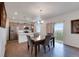 Bright dining area with stainless appliances, kitchen island, and outdoor view at 1800 Vantage Pkwy, Berthoud, CO 80513