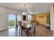 Bright dining area with a marble-top table, comfortable seating, sliding glass doors to the outside, and open to living room at 1800 Vantage Pkwy, Berthoud, CO 80513