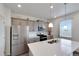 Modern kitchen featuring gray cabinets, stainless steel appliances, white countertops, and a spacious island at 1800 Vantage Pkwy, Berthoud, CO 80513
