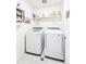Modern laundry room featuring side-by-side washer and dryer and organized shelving at 1800 Vantage Pkwy, Berthoud, CO 80513