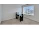 Bright office with modern desk, large window offering views, and neutral carpeting at 1800 Vantage Pkwy, Berthoud, CO 80513