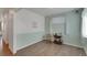 Bright and airy room showcasing pale-green walls, hardwood floors, bright windows and a vintage table at 1800 Vantage Pkwy, Berthoud, CO 80513
