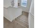 Carpeted staircase with white walls, providing a clean and modern transition between floors at 1800 Vantage Pkwy, Berthoud, CO 80513