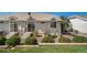 Backyard patio with sliding glass door, steps, and landscaping including shrubs and a low brick wall at 3104 Newport Cir, Castle Rock, CO 80104