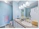 Well-lit bathroom with double sinks, white cabinets, and a large mirror at 3104 Newport Cir, Castle Rock, CO 80104