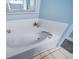 Bathroom featuring a large bathtub with white tile surround at 3104 Newport Cir, Castle Rock, CO 80104