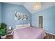 Relaxing bedroom with vaulted ceilings, light blue walls, and decorative leafy-themed wall art at 3104 Newport Cir, Castle Rock, CO 80104