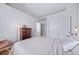 Inviting bedroom featuring neutral tones, a wood dresser, and access to closet at 3104 Newport Cir, Castle Rock, CO 80104