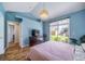 Spacious bedroom featuring blue walls, vaulted ceilings, and sliding glass door to outdoor space at 3104 Newport Cir, Castle Rock, CO 80104