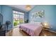 Bright bedroom featuring vaulted ceilings, blue walls, and sliding glass door leading to outdoor space at 3104 Newport Cir, Castle Rock, CO 80104