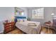 Cozy bedroom featuring a blue headboard, wood floors, and a bright window at 3104 Newport Cir, Castle Rock, CO 80104