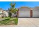 Home with a well-maintained lawn, a two-car garage, and a patriotic display at 3104 Newport Cir, Castle Rock, CO 80104