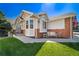 Charming home with a well-manicured lawn and a cozy front porch with decorative elements at 3104 Newport Cir, Castle Rock, CO 80104