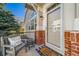 Inviting front porch featuring a cozy chair, decorative pillow, and a 'Home Sweet Home' welcome mat at 3104 Newport Cir, Castle Rock, CO 80104