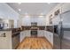 Bright kitchen with stainless steel appliances, granite counters, and wood laminate floors at 3104 Newport Cir, Castle Rock, CO 80104