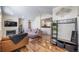 Open-concept living room featuring hardwood floors, modern decor, and a view into the kitchen at 3104 Newport Cir, Castle Rock, CO 80104