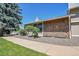 Side view of the house with a walkway and mature landscaping at 10321 E Evans Se Ave # 176, Aurora, CO 80247