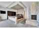 Main bedroom with a king-size bed, fireplace and built-in shelving at 10321 E Evans Se Ave # 176, Aurora, CO 80247