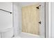 This bathroom features a tile surround, a shower with new fixtures, and a white toilet at 17003 E Tennessee Dr # 209, Aurora, CO 80017