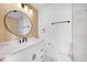 Bathroom with stand alone sink, marble countertops, wood backsplash, and modern fixtures at 17003 E Tennessee Dr # 209, Aurora, CO 80017