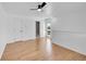 Spacious bedroom with hardwood floors, crisp white walls, and multiple closets and doors at 17003 E Tennessee Dr # 209, Aurora, CO 80017