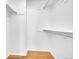 Spacious walk-in closet featuring hardwood floors and plentiful rod and shelf storage at 17003 E Tennessee Dr # 209, Aurora, CO 80017
