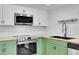 Green and white kitchen featuring wood countertops, subway tile backsplash, and stainless steel appliances at 17003 E Tennessee Dr # 209, Aurora, CO 80017