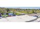 This view from the roof shows a parking lot and green space with walking paths and a pond at 17003 E Tennessee Dr # 209, Aurora, CO 80017