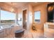 Bright bathroom featuring a tub, marble counters, and a large window with views at 19647 Guildford Ct, Monument, CO 80132