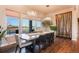 Dining room with a large window view, modern lighting, and a unique wood accent wall at 19647 Guildford Ct, Monument, CO 80132