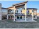 Contemporary home with a large balcony, stone accents and manicured landscaping at 19647 Guildford Ct, Monument, CO 80132