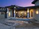 Inviting covered porch with exterior lighting, stone columns, and ample seating area at 19647 Guildford Ct, Monument, CO 80132