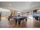 Spacious game room with hardwood floors, ping pong table, foosball table and built in shelves at 19647 Guildford Ct, Monument, CO 80132
