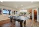 Game room with large windows, wood floors, ping pong table and foosball table at 19647 Guildford Ct, Monument, CO 80132