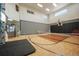 Spacious indoor gym with basketball court, climbing wall, and high ceilings at 19647 Guildford Ct, Monument, CO 80132