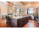 Elegant kitchen featuring a large island with bar stools, modern appliances, and hardwood floors at 19647 Guildford Ct, Monument, CO 80132