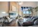 Spacious living room with a modern fireplace, hardwood floors, and stylish furnishings at 19647 Guildford Ct, Monument, CO 80132