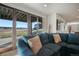 Living room featuring sliding glass doors with scenic views and comfortable couch at 19647 Guildford Ct, Monument, CO 80132