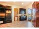 Mud room with built-in cabinets, granite counters, and access to the outdoors at 19647 Guildford Ct, Monument, CO 80132