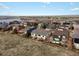 Aerial view showcasing a suburban community, a large pond and a fenced backyard at 8501 Hackamore Rd, Littleton, CO 80125