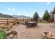 Spacious outdoor patio area with stone pavers, ample seating, a cozy fire pit, and mountain views at 8501 Hackamore Rd, Littleton, CO 80125