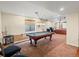 Finished basement with pool table, lounge area with leather sofas, and plenty of space at 8501 Hackamore Rd, Littleton, CO 80125