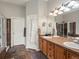 Bathroom featuring double vanity, walk-in shower, and separate toilet room at 8501 Hackamore Rd, Littleton, CO 80125